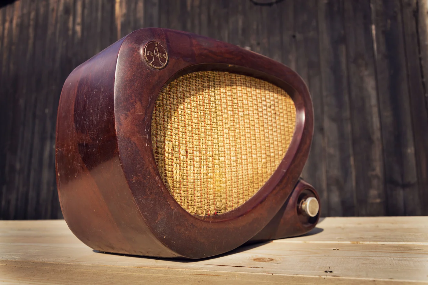 Old brown vintage bakelite Tesla radio on wooden background