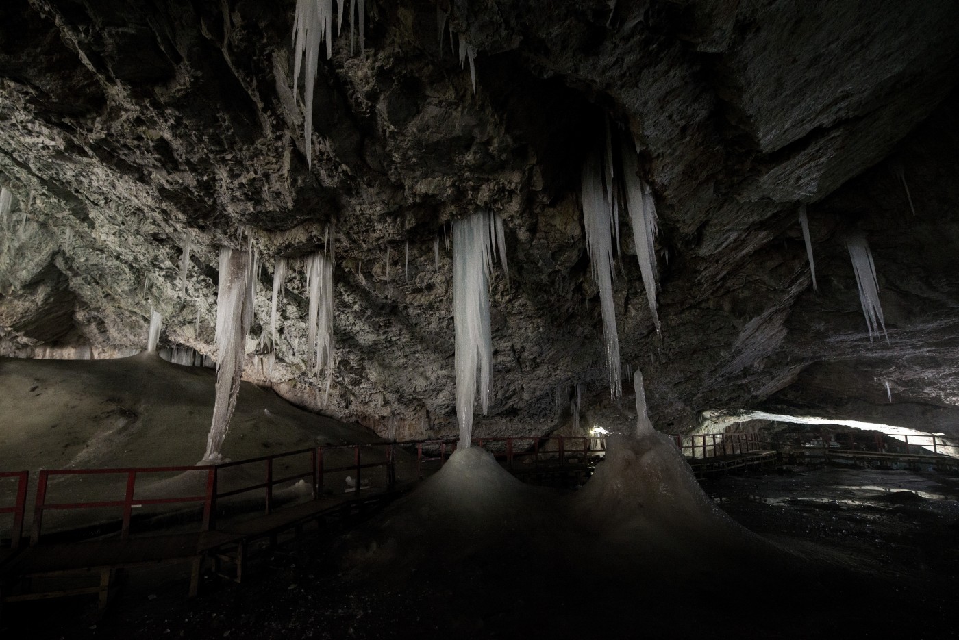 Underground glacier in Glaciers Cave in Apuseni mountains, Scarisoara, Romania. Big icicles holding on ceiling in the cave, Underground glacier in Glaciers Cave in Apuseni mountains, Scari
