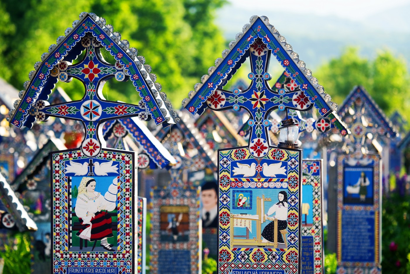 Blue painted wooden crosses in the Merry Cemetery in Maramures, an unique and amusing monument in the entire world, Blue painted wooden crosses in the Merry Cemetery in Maramures,
