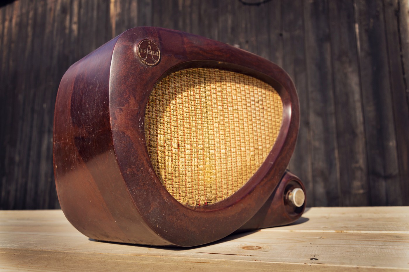 Old brown vintage bakelite Tesla radio on wooden background
